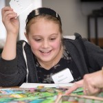 A helping hand directs a student to the proper location for her artistic contribution.