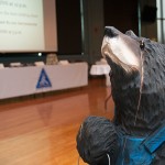 Who can resist THAT face? A hand-carved wooden bear appears to sniff out buyers in the Bush Campus Center air.