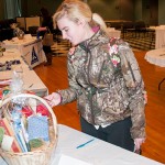 Emily E. Grimes, of Coalport, a pre-dental hygiene student, surveys the sale items.