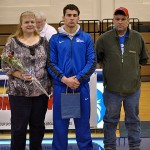 Joined by his parents, senior wrestler Joe Champluvier is honored in Bardo Gym.