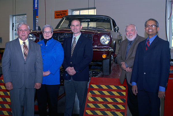 A student-restored 1965 Mustang provides a fitting backdrop for a photo op. From left are Colin W. Williamson; President Davie Jane Gilmour; Mike Moncilovich, national coordinator of Ford's technical career entry programs (who was instrumental in lining up the day's speakers); Robert C. Kreipke and K. Venkatesh Prasad.