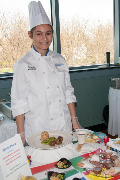 Hannah E. Marquis, of Olney, Md., presents her “World Piece” menu with an entrée of African bobotie meatballs, fruited Israeli couscous and Asian edamame salad, and dessert of Spanish churros with Aztec-style hot chocolate sauce.