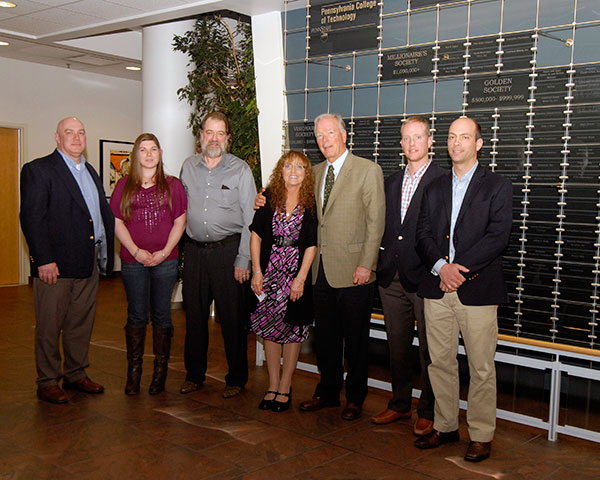 Principals of Amerikohl Mining Inc. and the family of Steelyn G. Kanouff gather near the SASC Donor Wall.