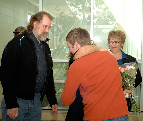 With flowers and overwhelming gratitude, Forrest S. Martin meets Steelyn G. Kanouff's parents, Gary and Ramona. At right is Debra M. Miller, Penn College's director of corporate relations.