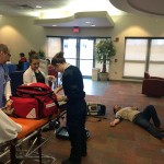 A crew deals with a kidney-stone attack in the Bush Campus Center TV lounge, preparing to transport the "patient" to the ATHS radiography lab.