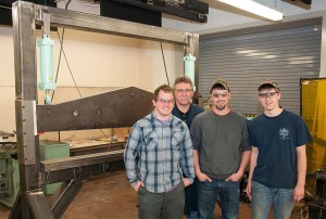 Keith H. English, instructor of automated manufacturing and machining, second from left, with three of the 25 Penn College students involved with manufacturing a press brake. The students, from left, are initial designer Jason B. Miller, manufacturing engineering technology, Mount Joy; Brandon M. Littlefield, automated manufacturing technology, Russell; and Michael A. Johnson, manufacturing engineering technology, Warren.