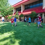 Excited over their new outdoor venue, boys and girls enjoy kickball, jump rope and other activities.