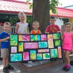 Some of the "Summer Bunch" show off artwork inspired by the Centennial Mosaic in the center of campus.
