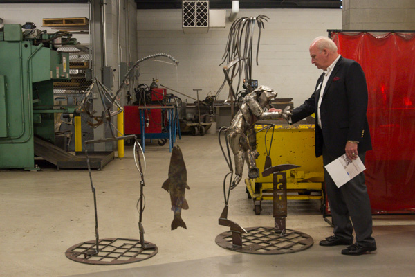 In the welding lab, Breuder inspects two of the metal creations being crafted for 