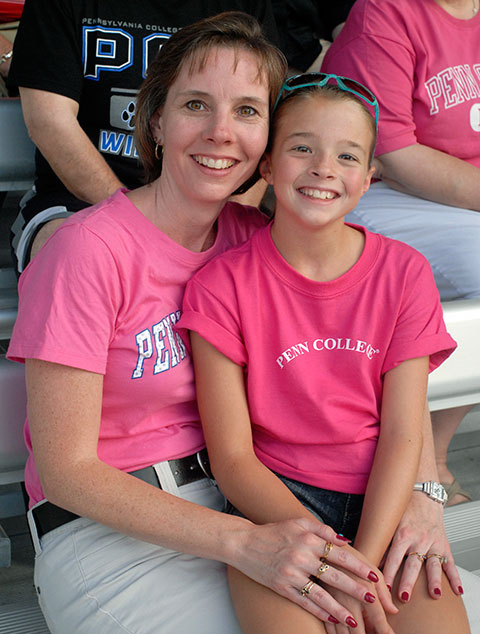 Enjoying family time at the ballpark are Tammy M. Rich, director of alumni relations, and daughter Ashley.