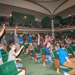 Students enthusiastically vie for T-shirts and other giveaways, rewards for correctly answering questions from the stage.
