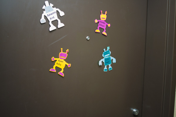 Out-of-this-world characters on a door announce the names of roommates beyond.