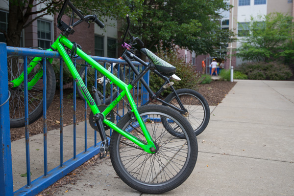 Bikes are secured in racks outside residence halls. 