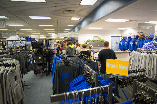 Business is booming in The College Store, with long lines in the back (for textbooks and supplies) and in front for clothing and other items.