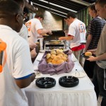 In the atrium of the PDC, Living-Learning Community students line up for engaging eats, including sandwiches, baked beans and macaroni salad.