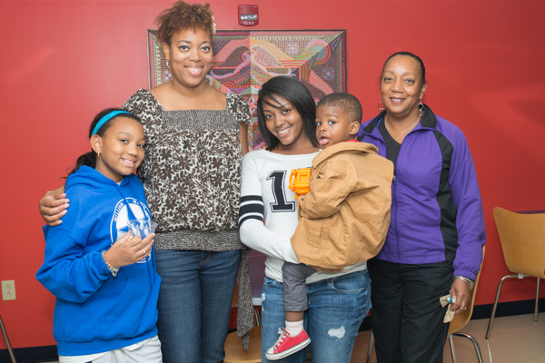 Kyani L. Lawrence (center), a first-year pre-nursing major from New Rochelle, New York, who also served as a Connections Link this summer, poses with her family in Wrapture.