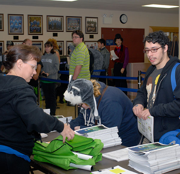 Roberta Schwenk, a circulation services assistant in Madigan Library, distributes 