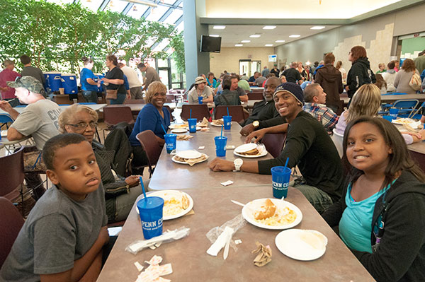 Antony L. Griffin-Betterson (center right), a residential construction technology and management major from Philadelphia, enjoys picnic fare with his family.