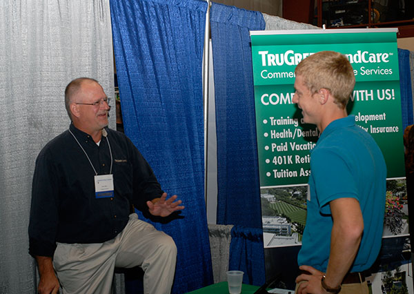Forest technology alumnus John A. Mraz, Class of 1985, gives one-on-one attention at the TruGreen LandCare booth.