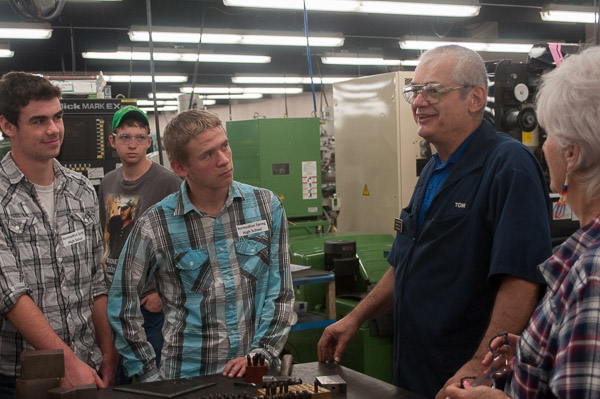 Tom Livingstone, associate professor of automated manufacturing and machining, talks with a group from Bermudian Springs High School amid the college’s electric discharge machining equipment.