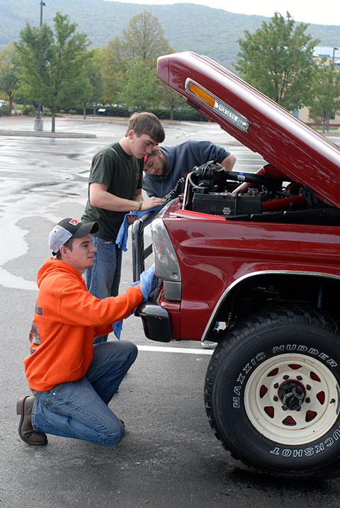 Garrett J. Maslonik (center), a diesel technology major from Patton, polishes his truck with help from Andrew J. Wassall (rear), of Manheim, a manufacturing engineering technology student, and Diesel Performance Club President Zachary A. Hurley, a diesel technology student from Six Mile Run.