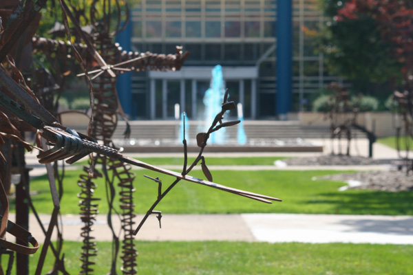 The “Wildcat Blue” fountain can be seen behind the metal artwork gracing the campus mall. 