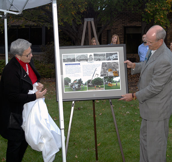 The president and Barry R. Stiger, vice president for institutional advancement, unveil a gift for Larry Allison Jr.: a reprint of the History Trail marker at the campus site of his company's forerunner, During her PM Exchange remarks, Gilmour recapped the breadth of work – highways, dams and industrial projects – undertaken during Lycoming Construction's pre-eminence.