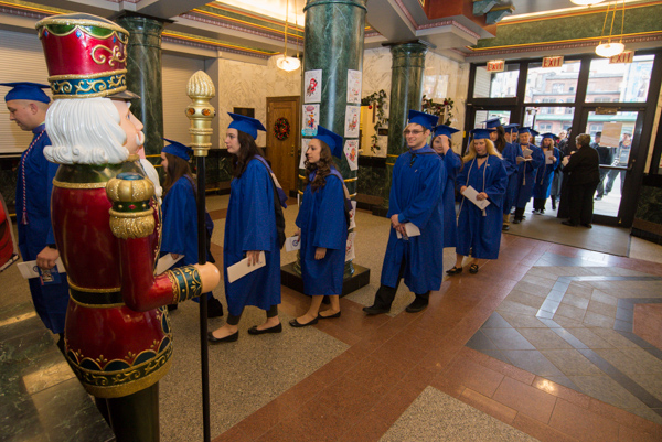 School of Business & Hospitality students file past a vigilant presence in the CAC lobby.