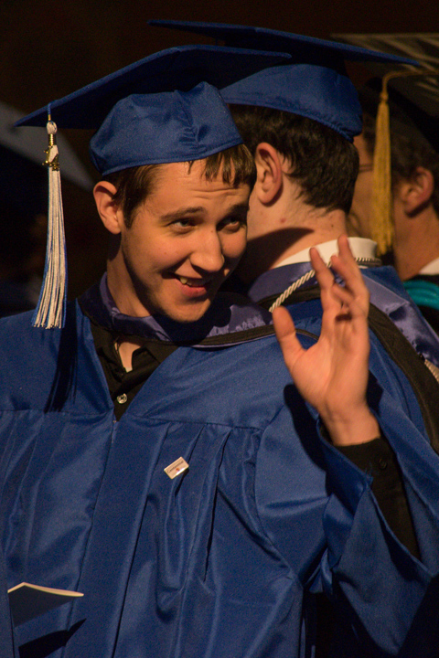 Sporting a Centennial pin on his gown, a student spots a familiar face.