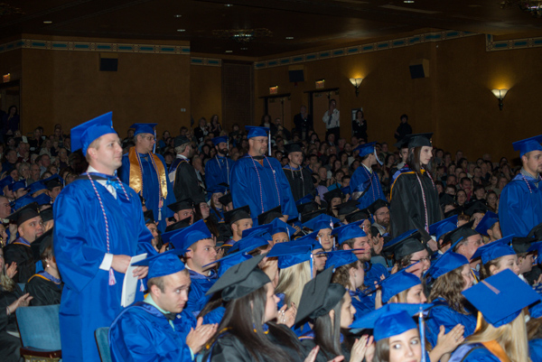 Veterans and active-duty military personnel stand to receive sustained applause from a grateful audience.