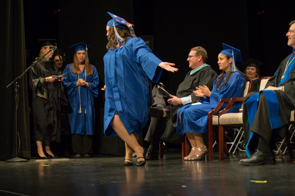 A curtsy to the crowd is among the crowd-pleasing antics of happy grads.