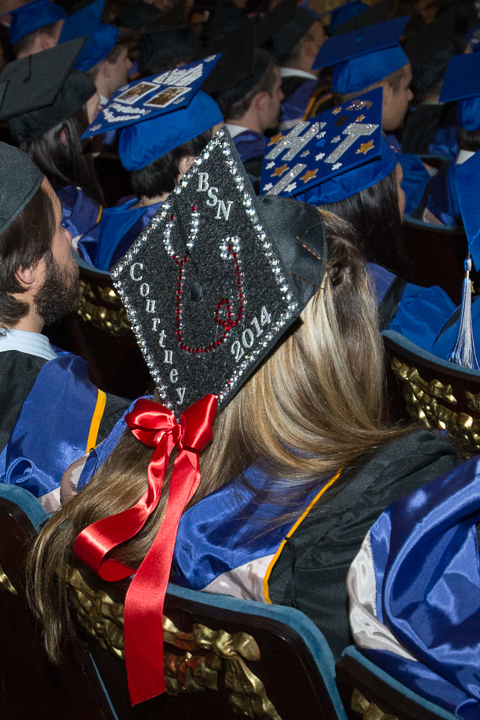 The cap of nursing graduate Courtney E. Servey is accented by a festive red ribbon.