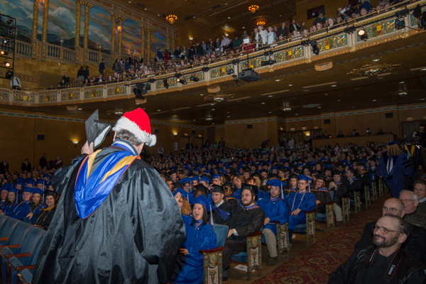 In a traditional move that humors the audience, Chef Paul E. Mach switches his academic headgear for a Santa hat ...