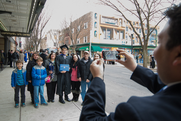 An impromptu photographer moves back to fit a sprawling family in the frame.