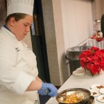 Culinary arts and systems student Brianna R. Helmick, of Hershey, prepares a chicken stir fry for visitors.