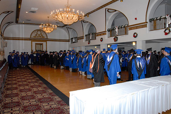 The procession forms in The Genetti Hotel before moving outdoors and down West Fourth Street.