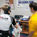 Susquehanna Valley Velo Club member Buffy Basile cycles while students Brittany M. Fisher, of Berwick, and Tyler Youngs, of Media, both sophomores in the physical fitness specialist major, monitor her performance.