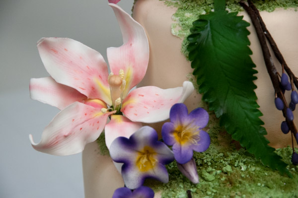 Edible details on Croney's cake include colorful flowers and moss.