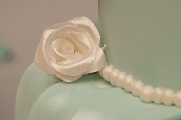 A delicate fondant rose adds detail to Fiedler's creation.