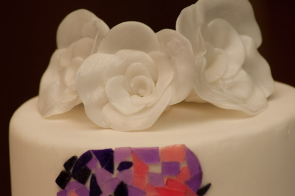 ... beautifully crowned by hand-formed white roses.