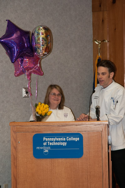 Chef Charles R. Niedermyer, instructor of baking and pastry arts/culinary arts, thanks Chef Sue L. Mayer, assistant professor of baking and pastry arts/culinary arts, for her years of organizing the cake competition. Mayer plans to retire this spring.
