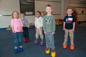 Youngsters in Penn College’s Children’s Learning Center practice their coordination skills on “stilts,” which are among the materials purchased through a grant to enhance physical activity and nutrition lessons.