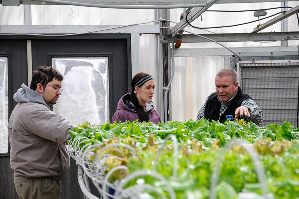 Student Daniel F. Clark (left), of Royersford, and horticulture instructor Carl. J. Bower Jr., take an Open House attendee through the hydroponic garden.