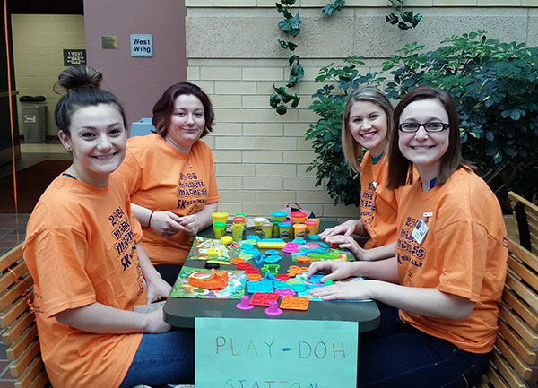 Awaiting visitors to the Play-Doh station are (from left) Natalie J. Cool, of North Bend; Shari L. Copp, of Muncy Valley; Amanda N. Gaugler, of Winfield; and Morgan A. Franc, of Lake Ariel.