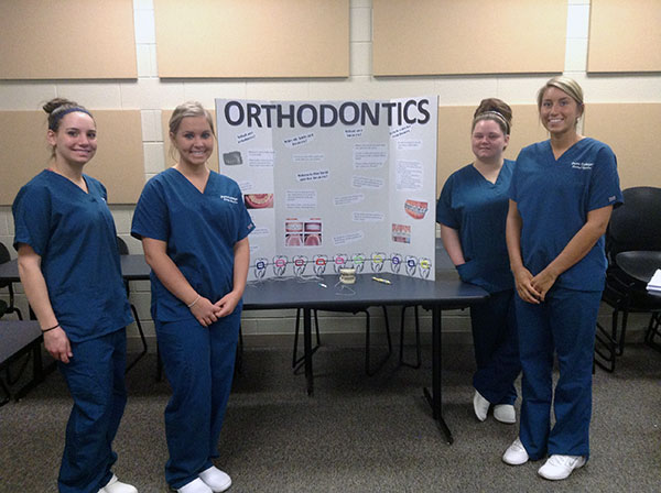 Presenting oral health information to parents and siblings of patients are (from left) Nicolette M. Petragnani, of Toughkenamon; Morgan E. Moberg, of Huntingdon; Ashley A. Totten, of Williamsport; and Chelsea E. Miller, of Chambersburg.