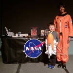 Cade Cassel assists storyteller Joanna Maddox, who portrayed astronaut Mae Jemison during Penn College's Feb. 2 Soul Food Dinner.
