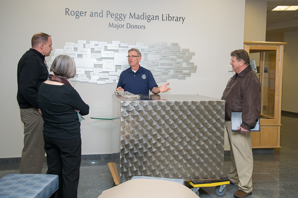 Marc E. Bridgens (right), dean of construction and design technologies, stops by to assess the glass-block work done by masonry students and faculty.
