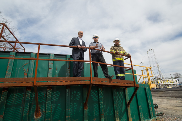 The governor ascends onto a storage tank with Craig Konkle (center), coordinator of the Lycoming County Department of Public Safety, and David C. Pistner.