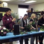 High school students create floral designs for the judges.