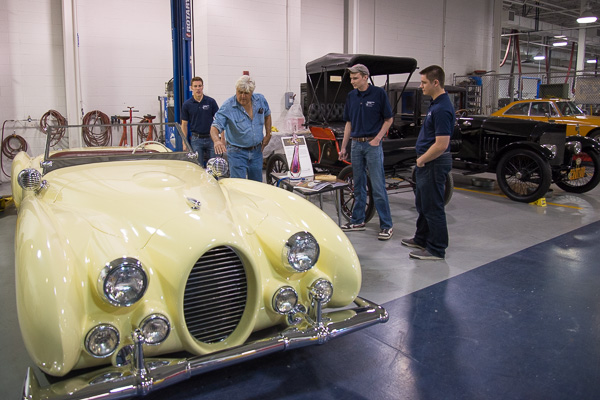 Leno first toured the restoration and collision repair labs. Here, he inspects the Verrill Wolf Wagon with student guides (from left) Andrew B. Switch, of Lancaster; Joseph M. Kretz, of Plymouth, N.H.; and Sean M. Hunter, of Livingston, N.J.
